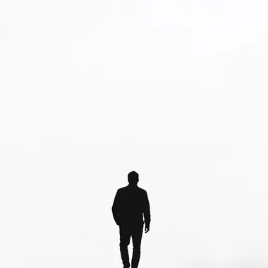 the shilouette of a man walking away from us, black and white, pure white bg