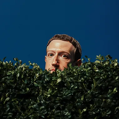 Mark Zuckerberg peeking over bushes with a blue background