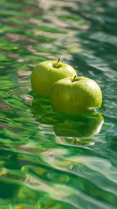 Two green apples are floating on the green water. The water has ripples and reflects the sunlight. The apples should be close to the color of the water and blend into the picture naturally and beautifully.  rofile 92dcoph --s 50