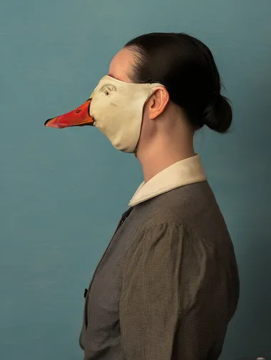 A melancholy photograph of the profile view of a girl wearing a vintage goose mask, in the style of Michael Borremans     rofile cq68b4z --oref