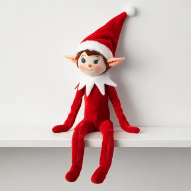 stuffed elf sitting left side on a shelf on white background