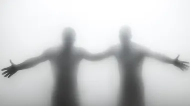 two figures holding hands behind a frosted glass, on a white background