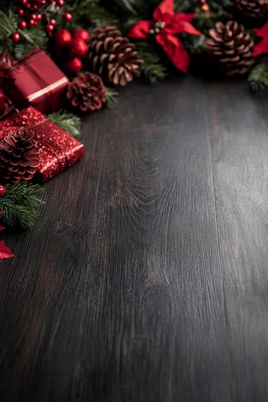 A dark wood floor background with red Christmas decorations, such as pine cones and gifts, around the edges of an empty space for magazine text or graphics.keep them small in size. The design is elegant and sophisticated, perfect for festive social media posts or digital marketing materials. It's a high-quality illustration that could be used in graphic designs, with a focus on creating an overall luxurious feel.
