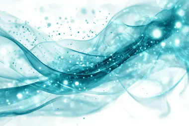 Teal and blue light particles move across a white background, leaving lines and trails in a uniform direction, flowing like a river of light, slightly out of focus.