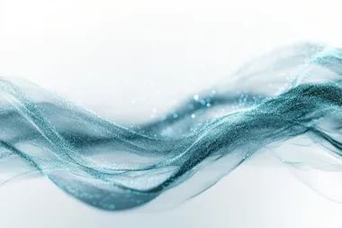 Teal and blue light particles move across a white background, leaving lines and trails in a uniform direction, flowing like a river of light, slightly out of focus.