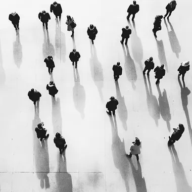 "Top-down view of people, minimalist black silhouettes, white background