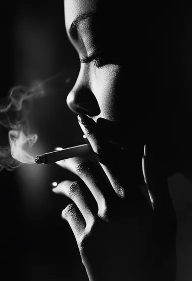 A close-up of the woman's hand, holding her cigarette between two fingers with light illuminating it from behind, creating an atmosphere of mystery and intrigue. The background is blurred to focus on the details of her hands, adding depth and texture to the overall composition. The black and white photography style adds contrast and intensity, highlighting the dramatic effect of the lighting. The woman is wearing .