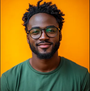 A handsome young man wearing a green shirt and glasses, smiling and holding an iPad in his hands, against an orange background. Professional photography with professional lighting.  --s 750