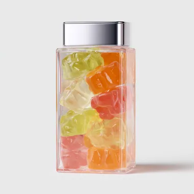 A realistic photo, a simple and cool transparent square bottle package, filled with large transparent gummies in pale colors. The gummies are shiny and jiggly. The background is white. A product from a cosmetic brand. A cool and simple unisex brand.