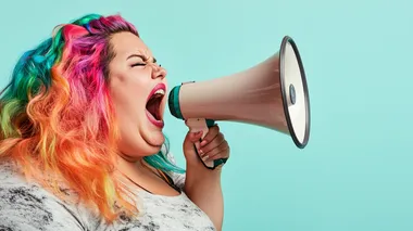 angry obese woman screaming into a megaphone. facing the right. rainbow colored hair. neutral background.