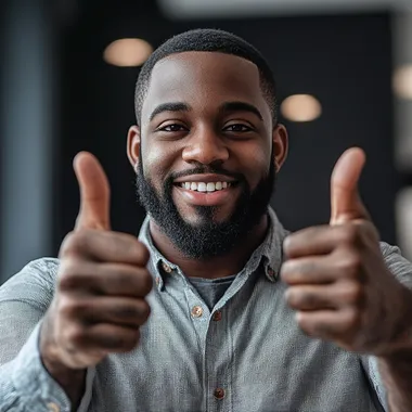 A well-built man raises his thumbs up in a sign of success