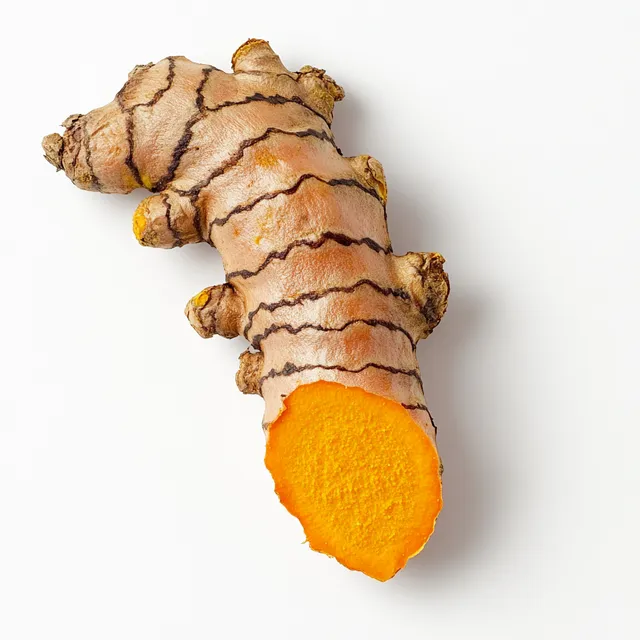 Close-up of turmeric root on white background, bright summer lighting