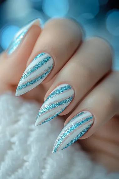 A photo of a woman's hand with long coffin nails with sparkly textured glitter of blue and white candy cane stripes