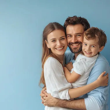 happy family (mom, dad, child) on a blue background they hug
