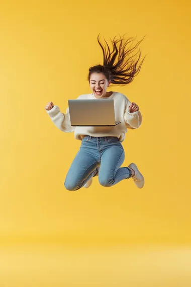 A person leap and holding a laptop, smiling, full-body shot, yellow background, studio photography, advertising style, high-resolution photography.