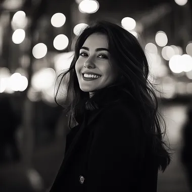 Realistic black and white photo happy girl with dark hair on the background of urban night landscape in black coat, atmosphere of joy and romance
