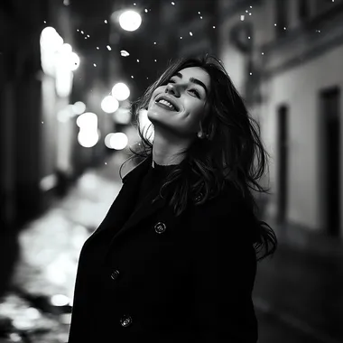 Realistic black and white photo happy girl with dark hair on the background of urban night landscape in black coat, atmosphere of joy and romance