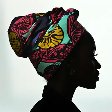 side profile silhouette of an isixhosa women's head wearing a colourful seshweshwe hair wrap