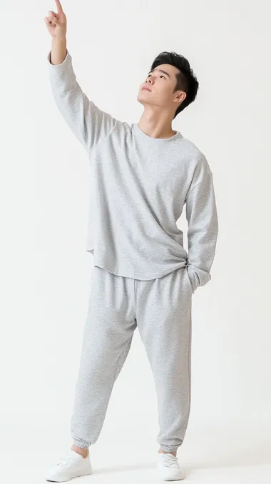 A Chinese male model, leaning sideways, looking up, standing on a white background, raising one arm, pointing upwards, wearing grey home clothes