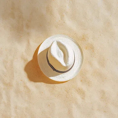 white hat, on sand background. Beach vacation concept .Top view with copy space, hyper realistic, 4K, --raw rofile 9o5bg9b