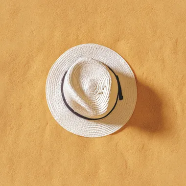 white hat, on sand background. Beach vacation concept .Top view with copy space, hyper realistic, 4K, --raw rofile 9o5bg9b