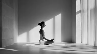 a woman and doing yoga in a minimal interior. her face is calm