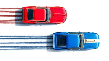 Sleek red 1969 Ford Mustang racing a blue 1991 Pntiac Firebird side by side leaving tire trails against a white backdrop behind the cars, top-down view creating a racing scene, cars are moving from left to right. retro feeling similar to 1970's car promotional posters, minimalist