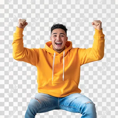 A white background studio with a stylish, modern sofa at its center. A young man in his mid-20s sits on the sofa, visibly excited, leaning slightly forward with a big smile on his face. Hes dressed casually in a bright hoodie and jeans, his hands raised mid-air as if celebrating a win or reacting to good news, with soft lighting, and a throw blanket adding warmth to the scene. The mood is energetic and uplifting, capturing a joyful moment.
