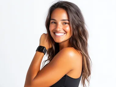 Girl at waist smiling. shows a black colored wristwatch on her hand. White background