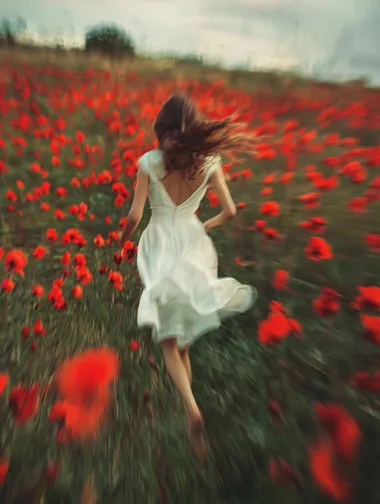 Retro movie style film photography,Slow shutter photography motion blur,A woman in a white dress ran through a field of red flowers,