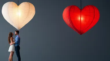 Silhouetted lovers standing under a glowing heart chandelier on a dark gray background , space for text  2231e8s     --s 250