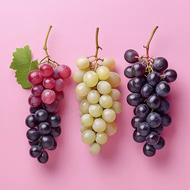 detailed photo of red wine grape, white wine grape and pink wine grape over a pink background