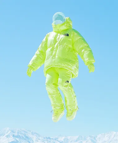 A bean green The North Face down jacket, flying in the sky above the snow-capped mountains. Product photography style, professional sports brand, blue sky background, clean background, a little dreamy color and halo, diagonal composition, high resolution, professional lighting and professional photography, high quality images, 32k    rofile m6levxq