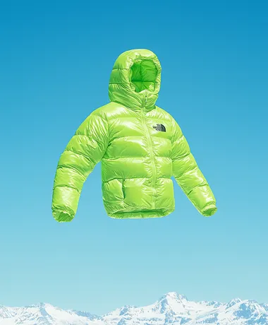 A bean green The North Face down jacket, flying in the sky above the snow-capped mountains. Product photography style, professional sports brand, blue sky background, clean background, a little dreamy color and halo, diagonal composition, high resolution, professional lighting and professional photography, high quality images, 32k    rofile m6levxq