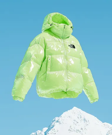 A bean green The North Face down jacket, flying in the sky above the snow-capped mountains. Product photography style, professional sports brand, blue sky background, clean background, a little dreamy color and halo, diagonal composition, high resolution, professional lighting and professional photography, high quality images, 32k    rofile m6levxq