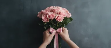Delicate hands tying a pink ribbon around a bouquet of pink roses, symbolizing love and appreciation, cinematic close-up.,    773tzfv