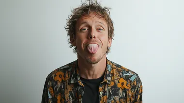 portrait photography of a standing, smart, cool, 40- year old skater guy sticking his tongue out, in modern clothes in front of a white background. from the waist up, Terry richards style