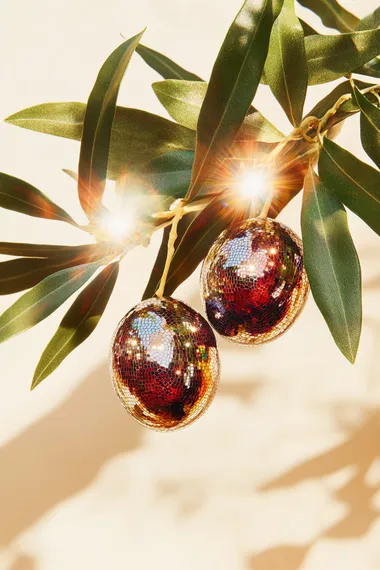 a bunch of black purple olives hanging from the realistic tree leaves, the olives is made out of mirror mosaic tiles disco on a cream colour background and shadows. hyperrealistic. high resolution print.   27rgi6y