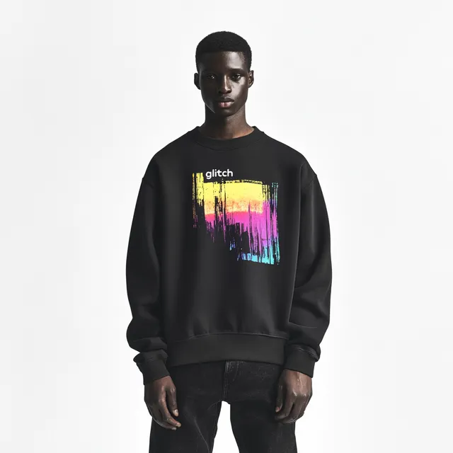 Man in oversized black sweatshirt and baggy jeans, streetwear style, urban