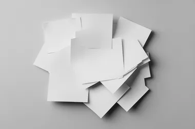 bundle of pieces of blank sticky note paper isolated on grey background , high quality photo,