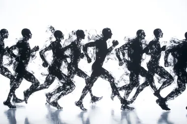 black shilouettes of running men and women finishing on white background