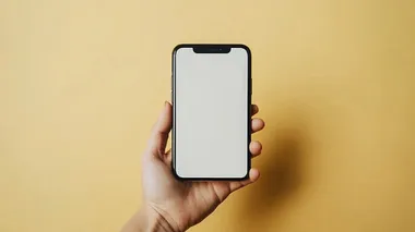 a frontal photo of a hand holding a blank iphone mockup. shot against a yellow studio backdrop. in the style of product photography. photorealism, hyper realistic, centered, symmetrical composition, extreme detail 8k style raw