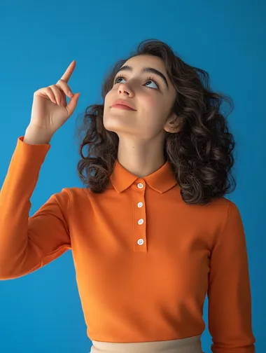 22 years old Turkish girl student wearing orange-long-sleeve polo shirt and beige skirt and smiling, look up and to show the top with his finger and thinking question at blue studio background, , minimalistic, wide angle, high detail, Sony a7iv,