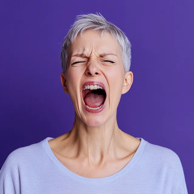 a woman with her eyes closed and her mouth wide open
