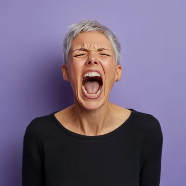 yelling mature woman with short hair on a periwinkle background