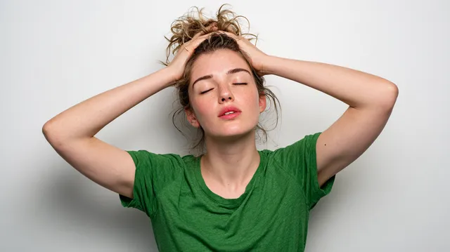 Overheated Young Woman Fanning Herself in Studio