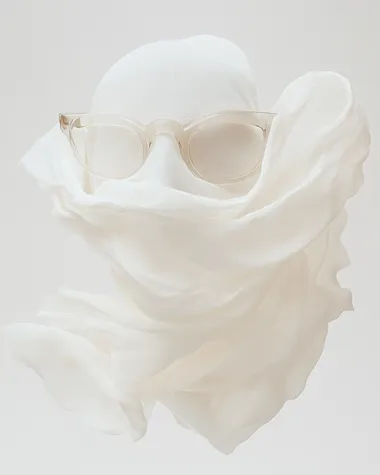 Thin and delicate amorphously organic glasses made of cloth material. Worn by a mobel   dl5ez83