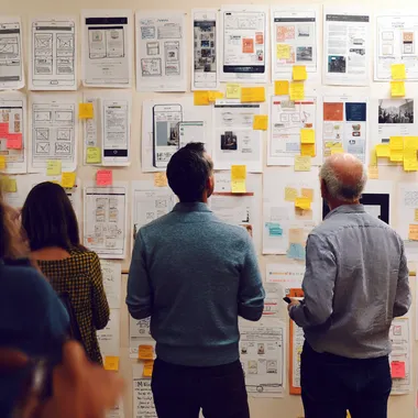 a room of individuals white-boarding concepts for a desktop shopping application rofile sgpey5s