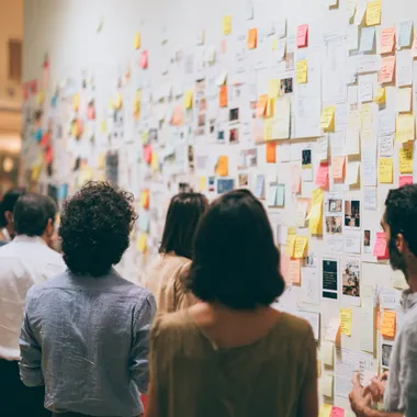 a room of individuals white-boarding concepts for a desktop shopping application rofile sgpey5s