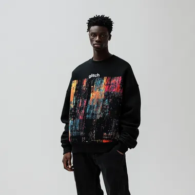imagine print for textile sweatshirt using as a main theme "glitch" on a black washed sweatshirt, oversized fit and round neck collar, worn by a man in black baggy jeans, white background, streetwear style, high-resolution photography